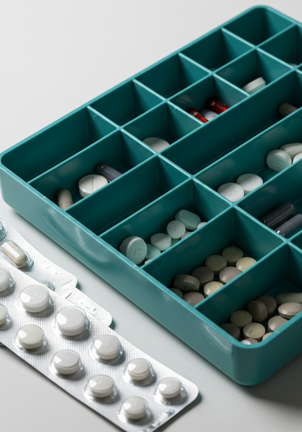 A person correctly taking medication twice daily, demonstrating adherence to a prescribed regimen like BID.