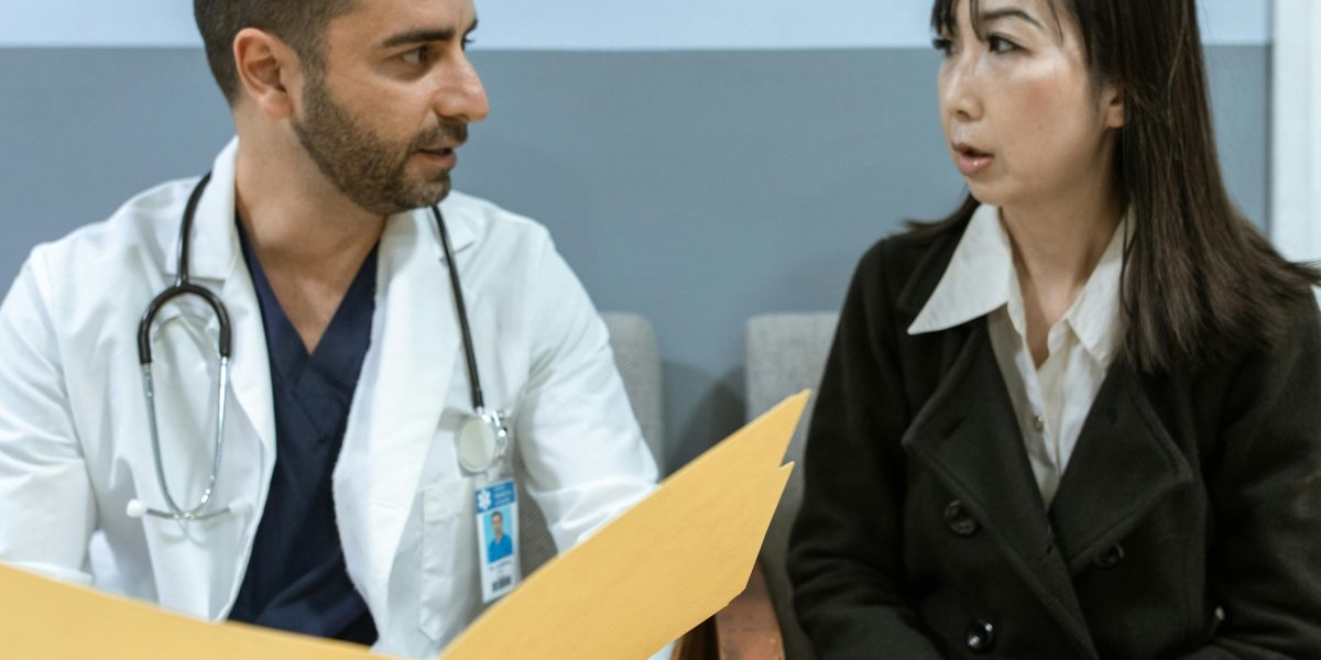 An empathetic discussion between a doctor and patient is vital for understanding symptoms and treatment paths.
