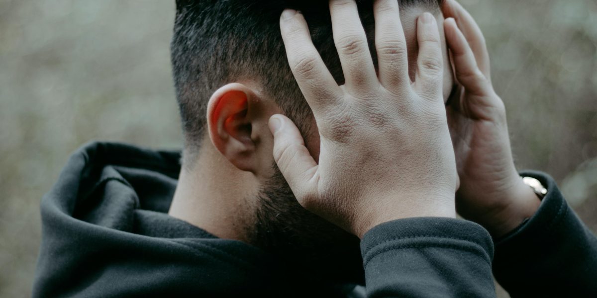 A person looking thoughtful and perhaps overwhelmed by many options.