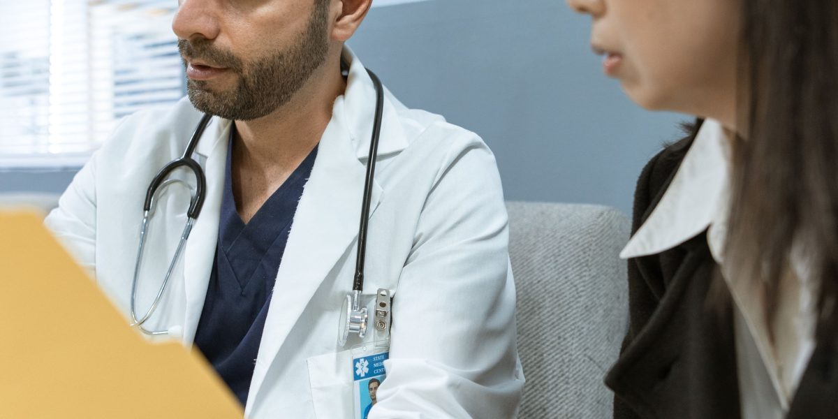 A patient actively discussing their treatment plan with a doctor, emphasizing collaborative decision-making.