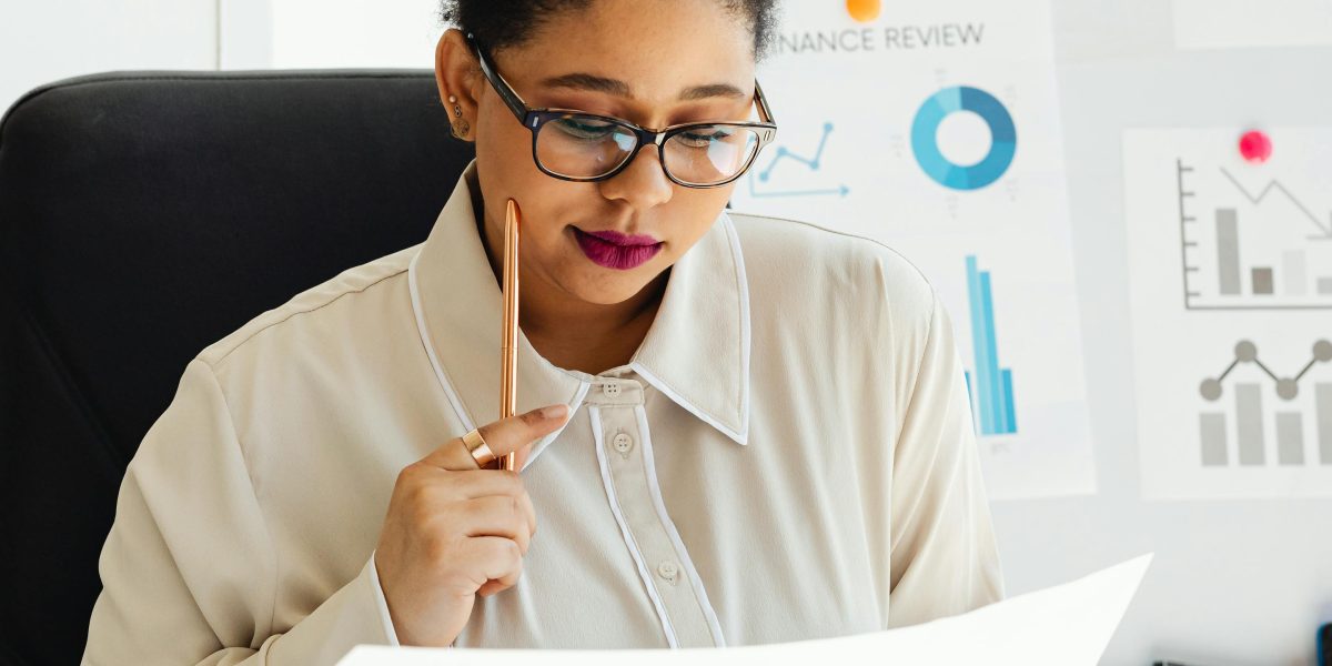 A person intently examining documents and reports, representing the critical analysis of mental health survey data.