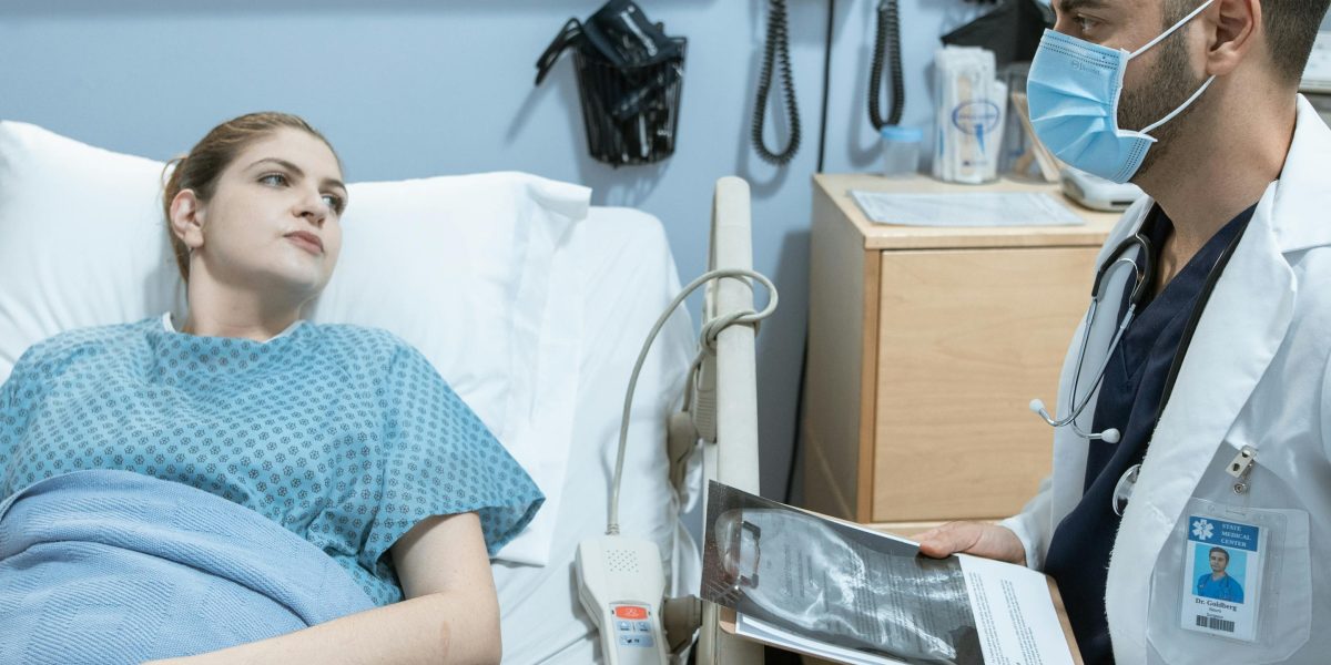 A medical professional explains complex diagnostic criteria to a patient in a calm setting.