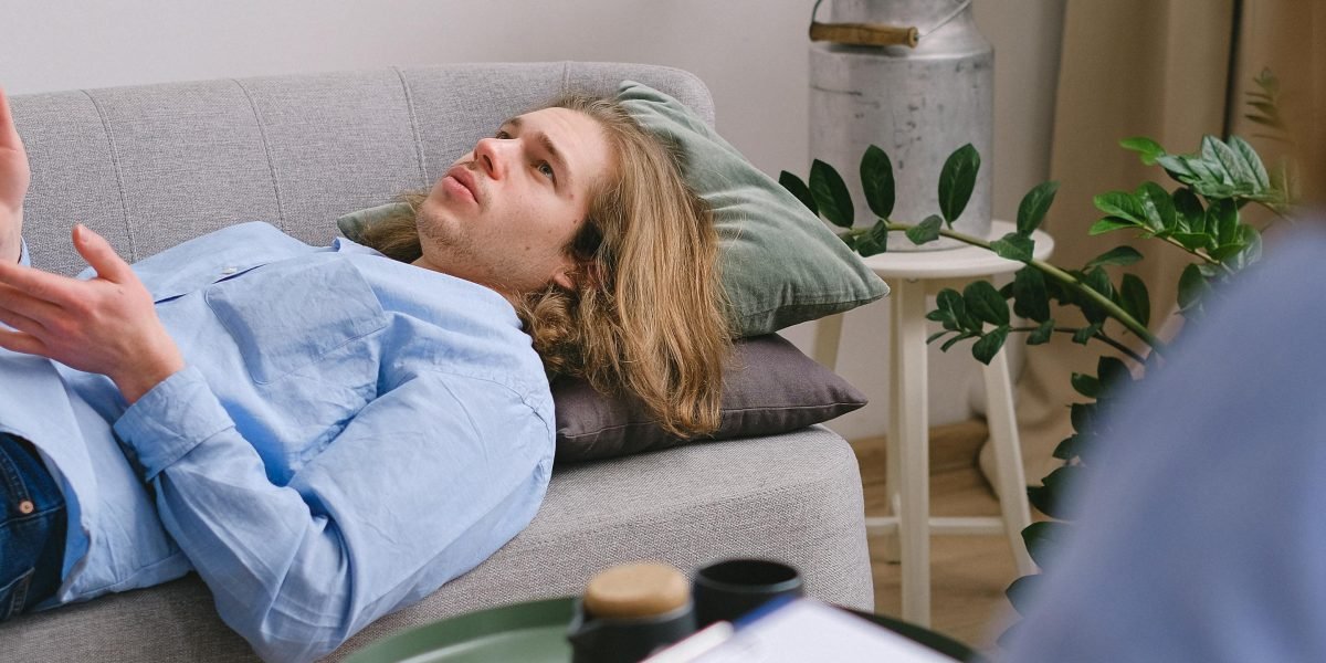 A mental health professional attentively listening to a client during a therapy session, emphasizing support and dialogue.