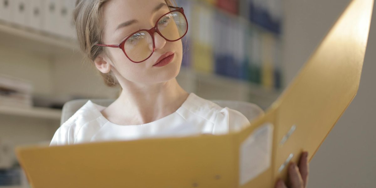 A person thoughtfully looking at documents or a screen, symbolizing the process of understanding information and planning next steps.
