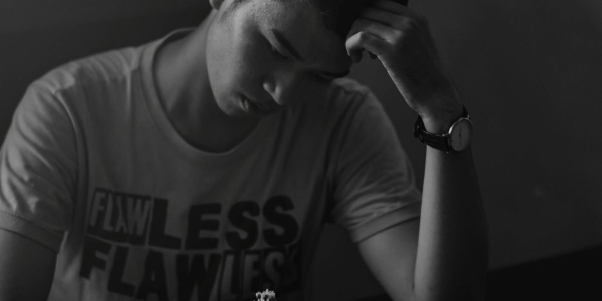 A person sits thoughtfully, reflecting on life's profound questions and purpose.