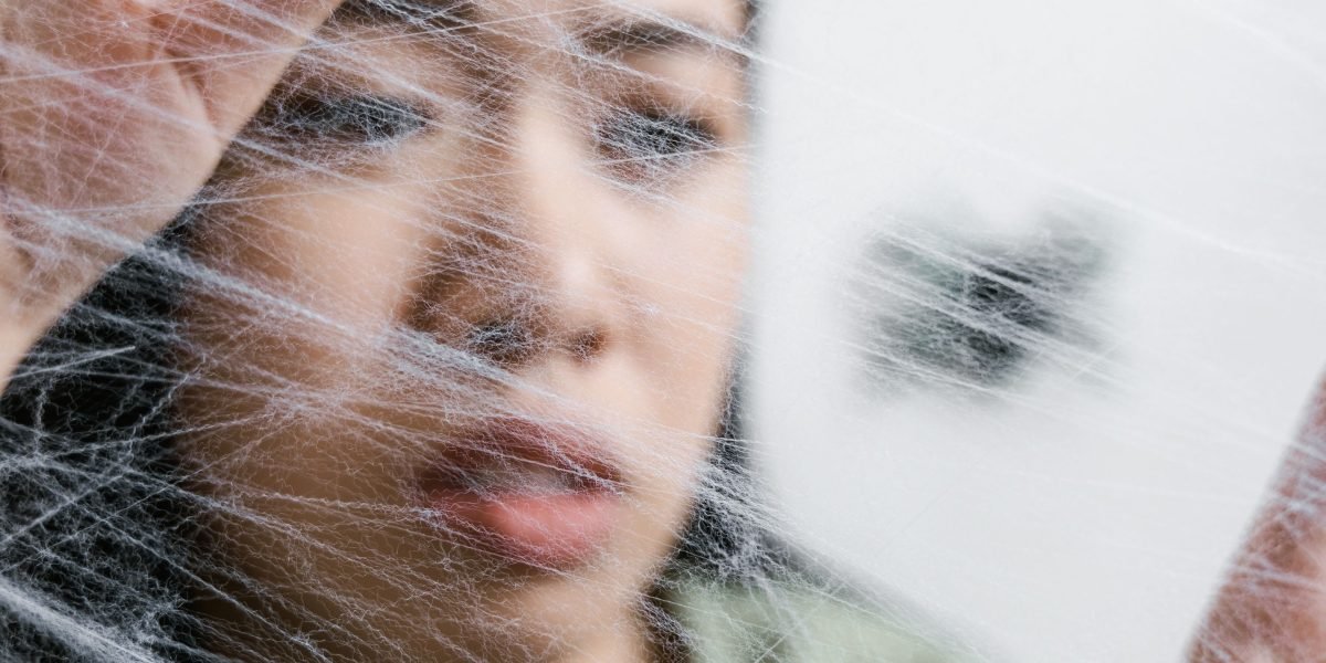 A person looking overwhelmed and distressed, reflecting the feeling of being trapped in a harmful relationship.