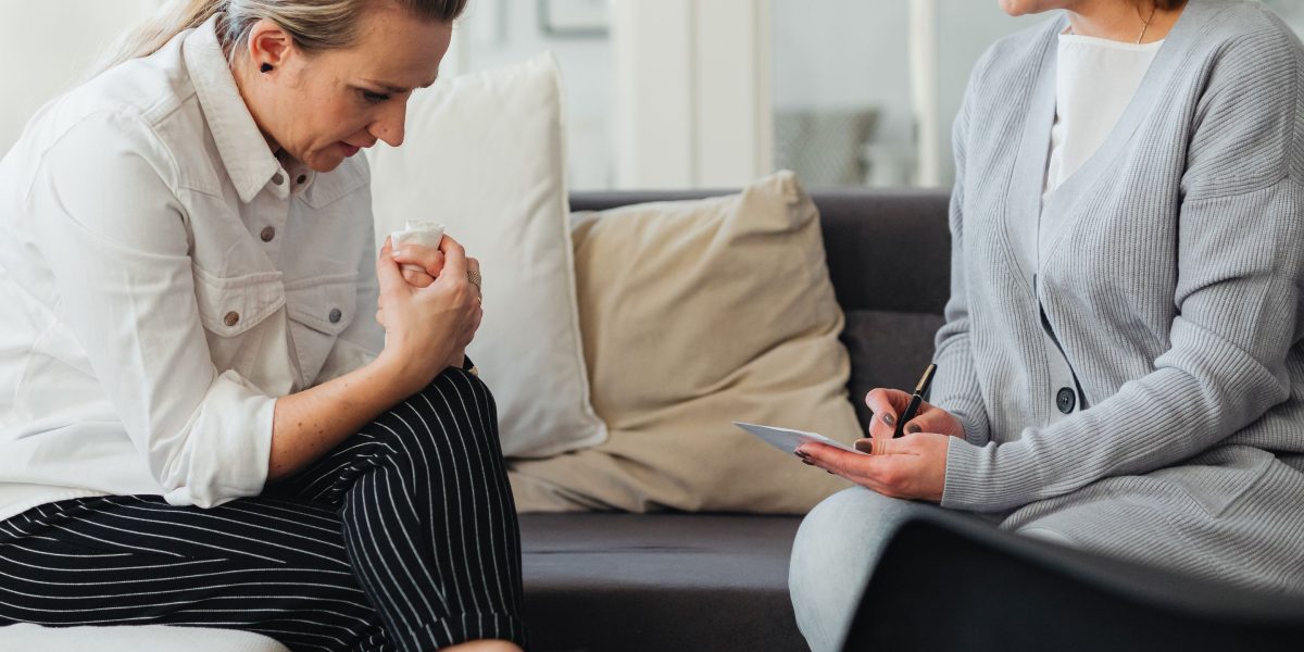 An individual engaging in a conversation with a therapist, emphasizing the importance of a trusting therapeutic relationship.
