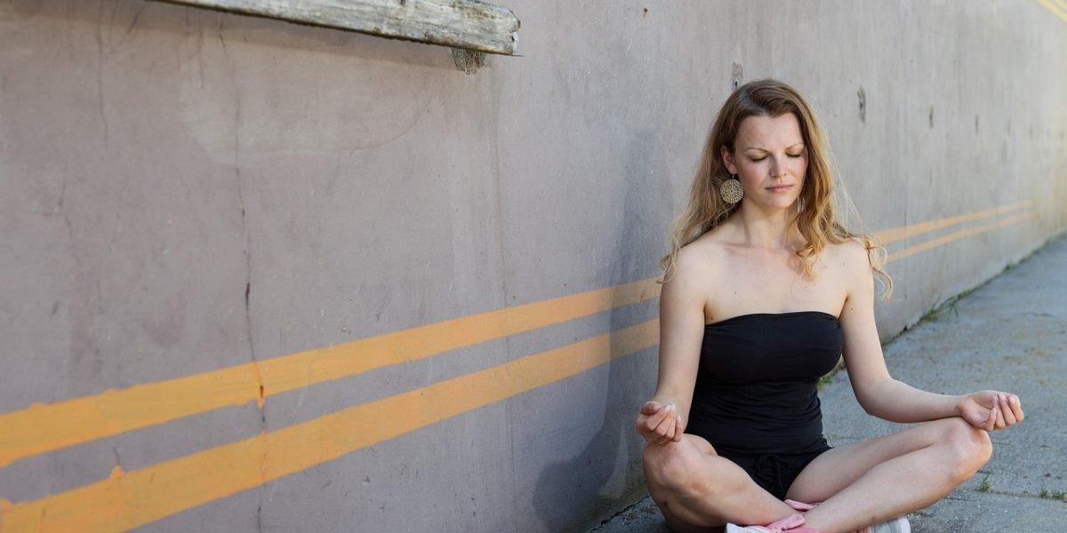 A person practicing yoga outdoors, reflecting the integration of wellness activities and nature access in luxury care.