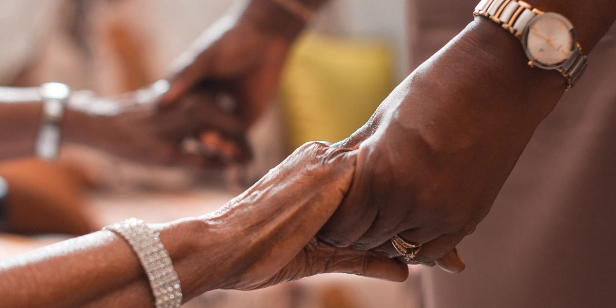 A family or group offering comfort and support to a veteran, highlighting the importance of caregiver involvement.