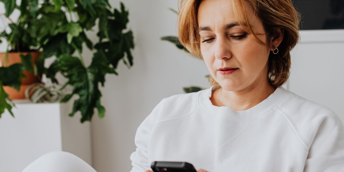A person finding a moment of calm and focus using a mental wellness tool on their mobile phone in a relaxed setting.