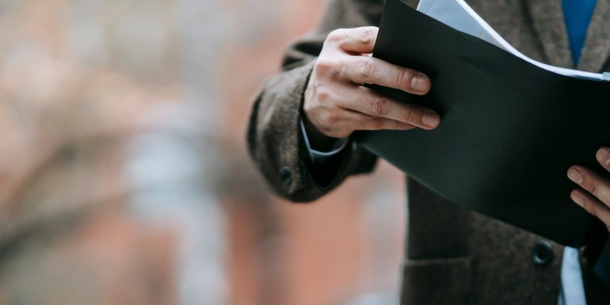 A person carefully reviewing documents or information, symbolizing the importance of checking privacy policies for apps.