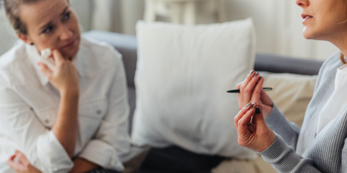 A compassionate therapist actively listening to a patient during a mental health evaluation, emphasizing understanding and support.