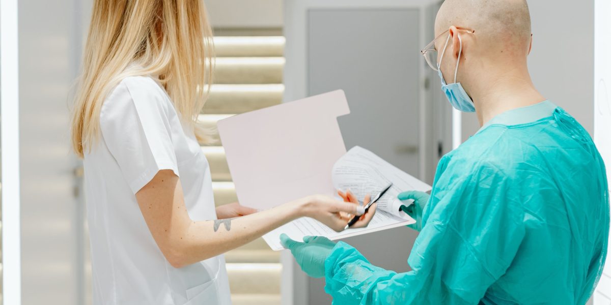 A group of medical professionals engaged in a serious discussion, likely about patient safety protocols and avoiding errors.