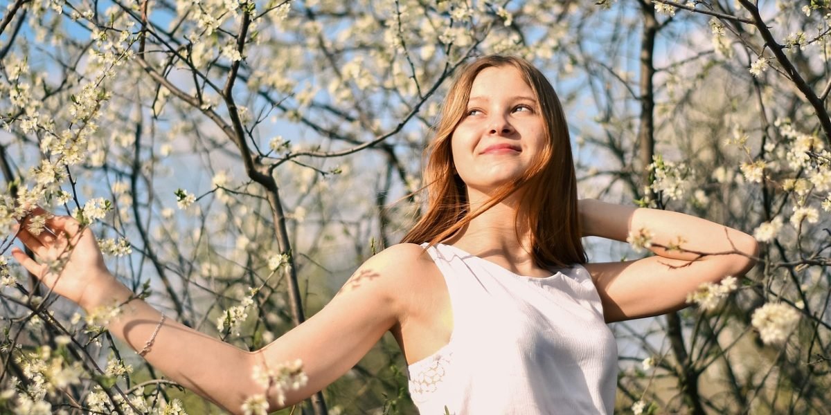 A person exuding confidence and joy, symbolizing sustainable wellness and mental well-being.