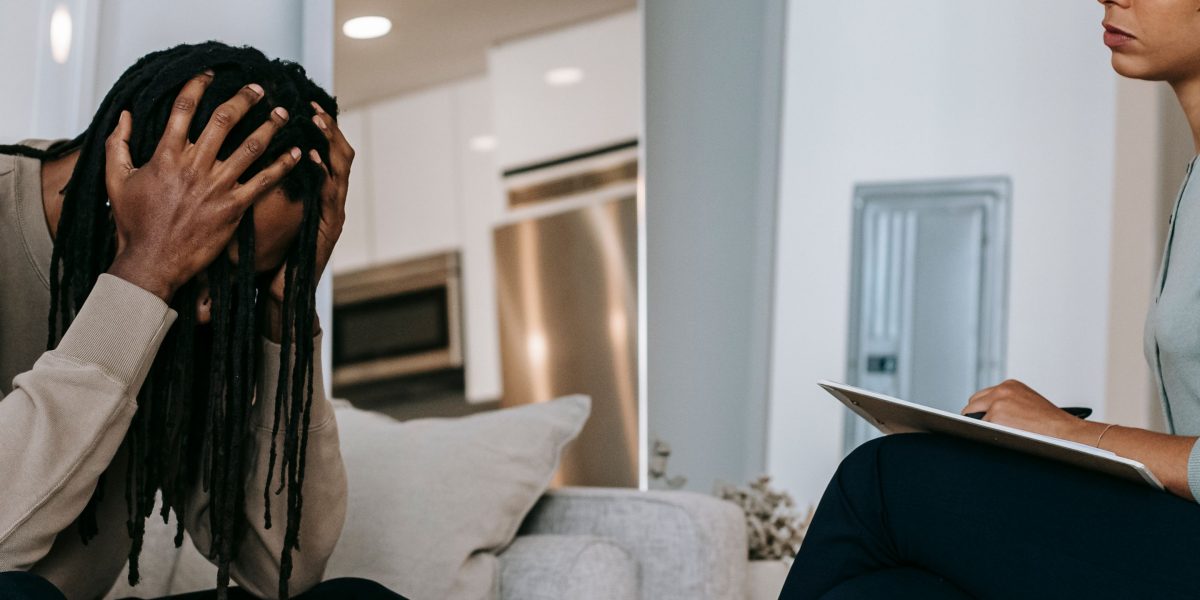 A patient engaged in an empathetic conversation with a therapist, representing the clinical interview step of diagnosis.